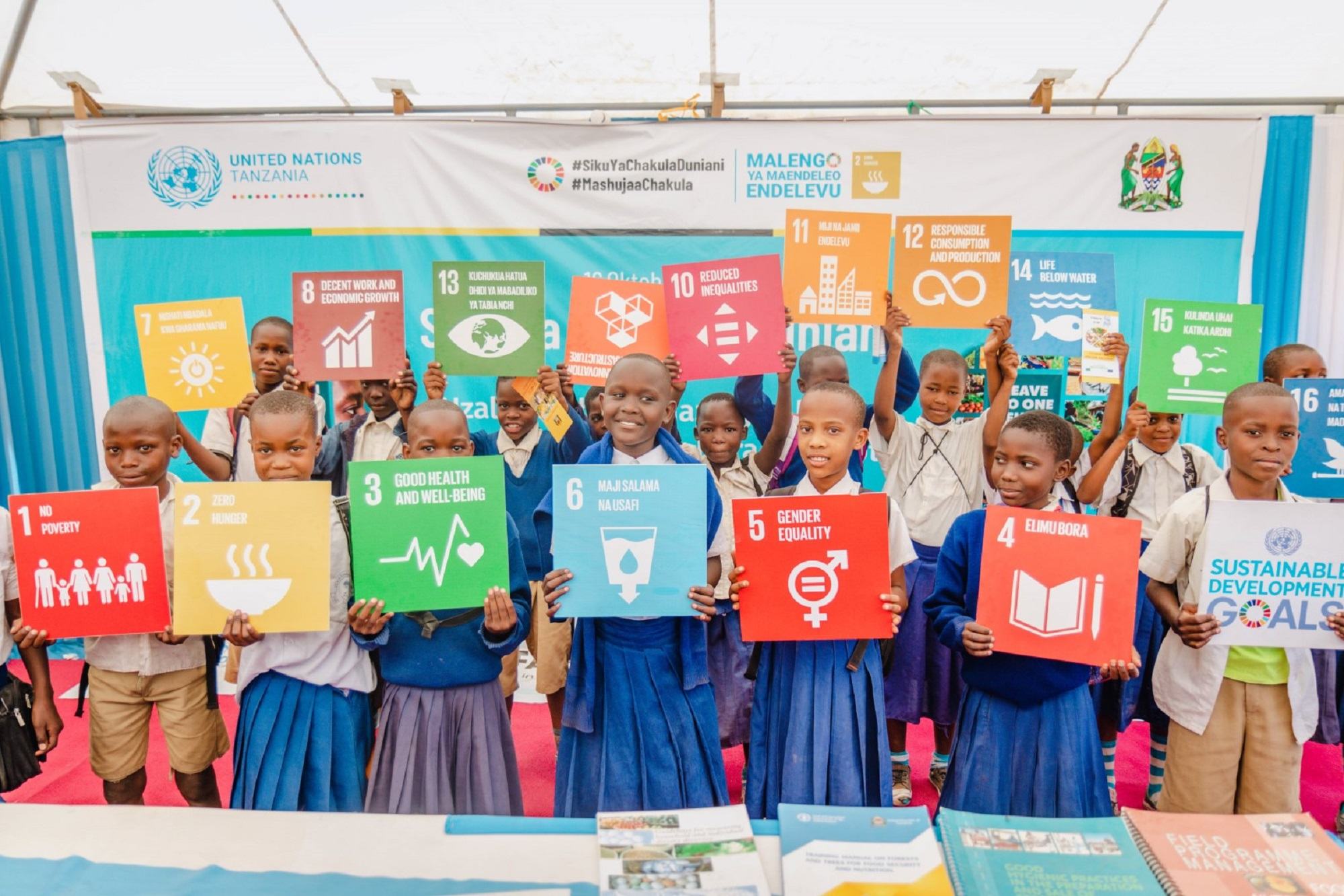 Students in Tanzania hold Sustainable Development Goals (SDGs) cards.