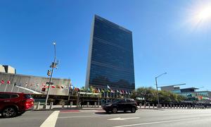 The Secretariat building with flags of Member States in the foreground, at UN Headquarters, in New York.