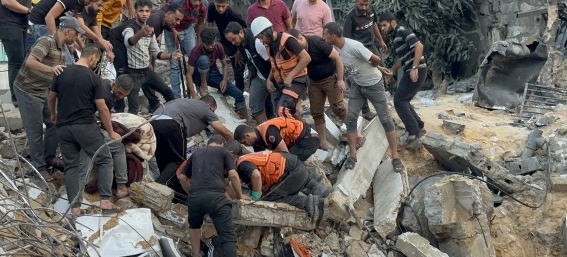 Palestinian civil defence responders search the rubble of a building in the aftermath of an air strike in the Gaza Strip. (file)