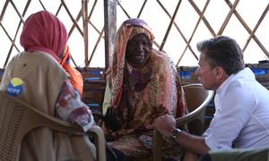 The UN's Emergency Relief Coordinator, Tom Fletcher, meets women at a site hosting displaced people in Tawila, Darfur.
