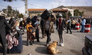 Thousands of people cross into Syria from Lebanon through the Masnaa border.