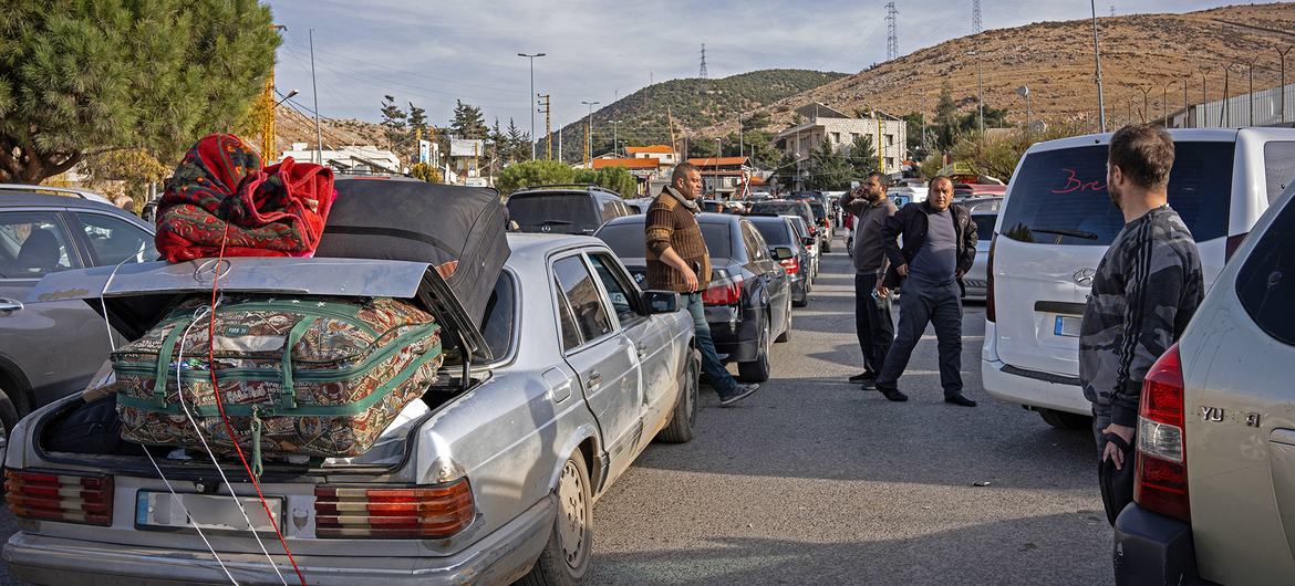 People cross back into Syria from Lebanon through the Masnaa border point.