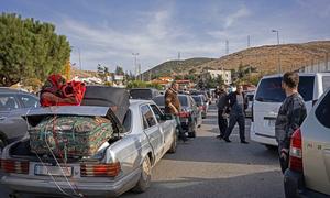 People cross back into Syria from Lebanon through the Masnaa border point.