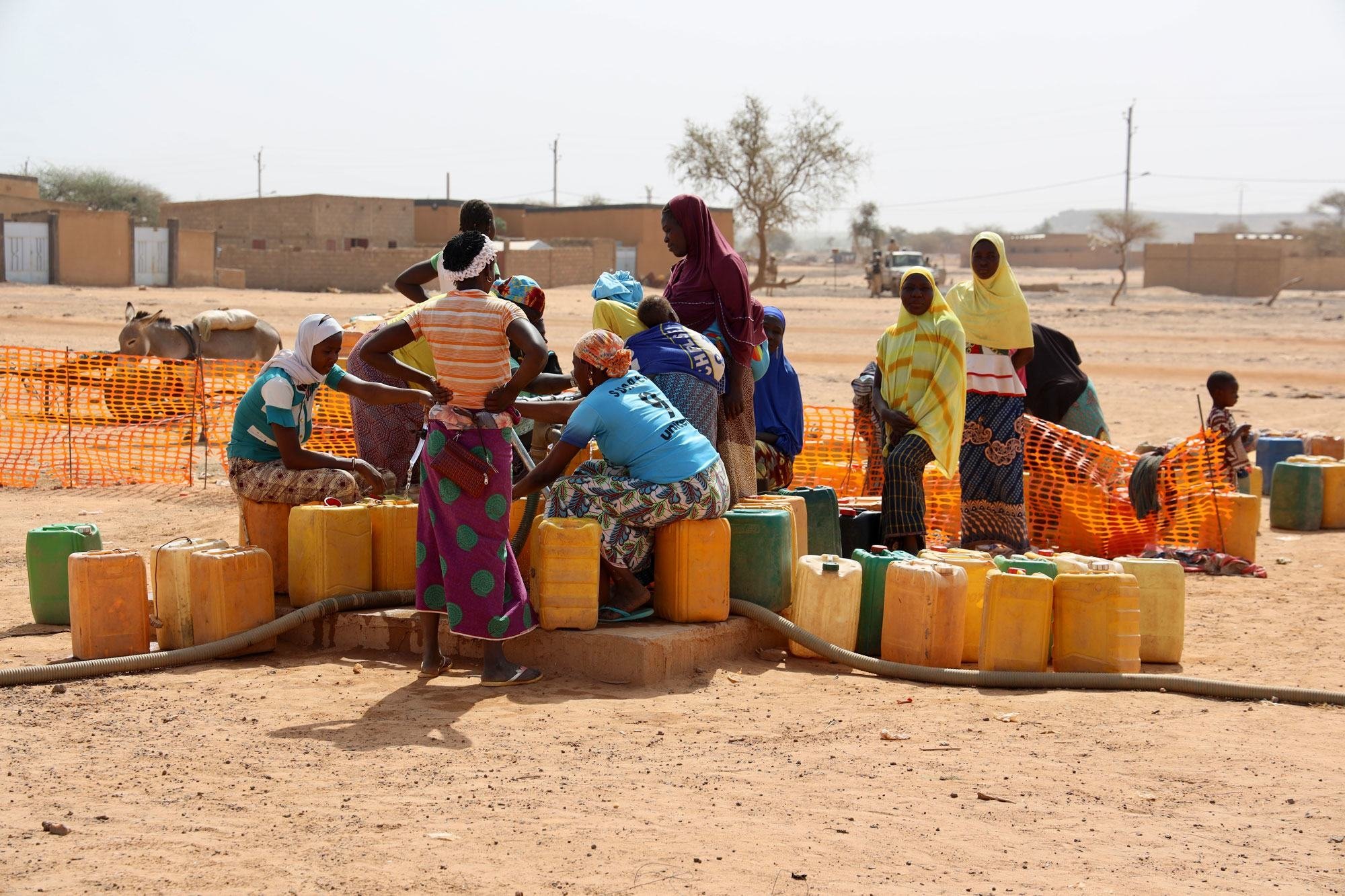 مجموعة من النازحات يجمعن المياه في مدينة جيبو في بوركينا فاسو.