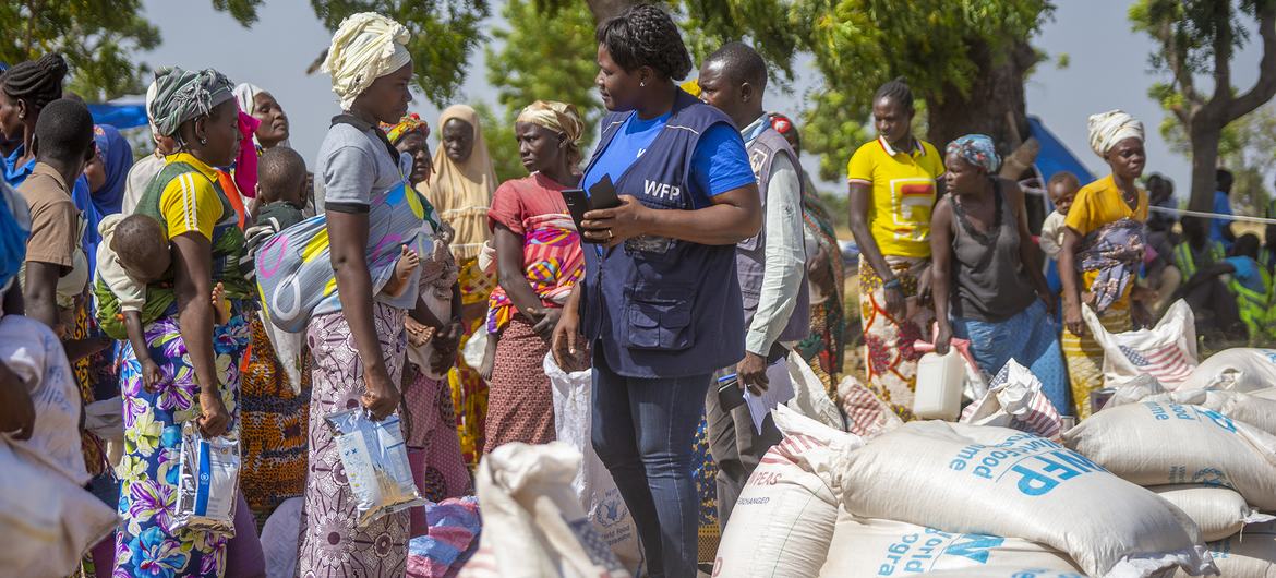 People displaced by conflict in Burkina Faso collect humanitarian relief supplies in the east of the country.