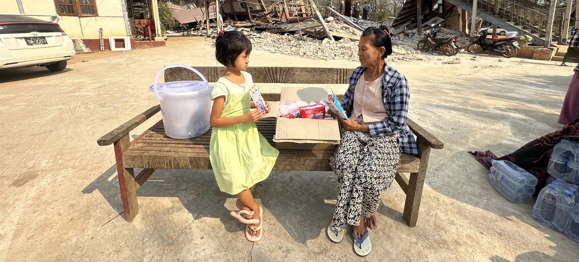 A woman and her granddaughter with relief supplies in a village in Mandalay, one of the regions hardest hit by the disaster. A woman and her granddaughter with relief supplies in a village in Mandalay, one of the regions hardest hit by the disaster.