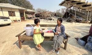 A woman and her granddaughter with relief supplies in a village in Mandalay, one of the regions hardest hit by the disaster.