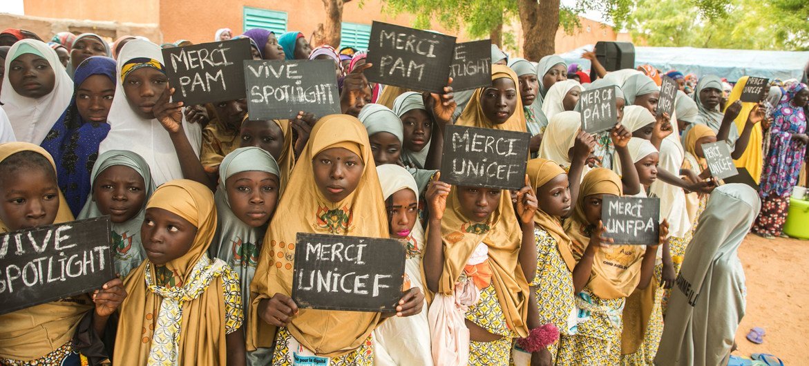 Ragazze del villaggio di Danja in Niger mostrano cartelli a sostegno dell'iniziativa Spotlight.