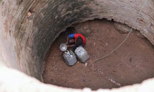 Millions across Sudan have been driven by the conflict between rival militaries. In this file photo, a child collects water from a deep well in central Darfur.