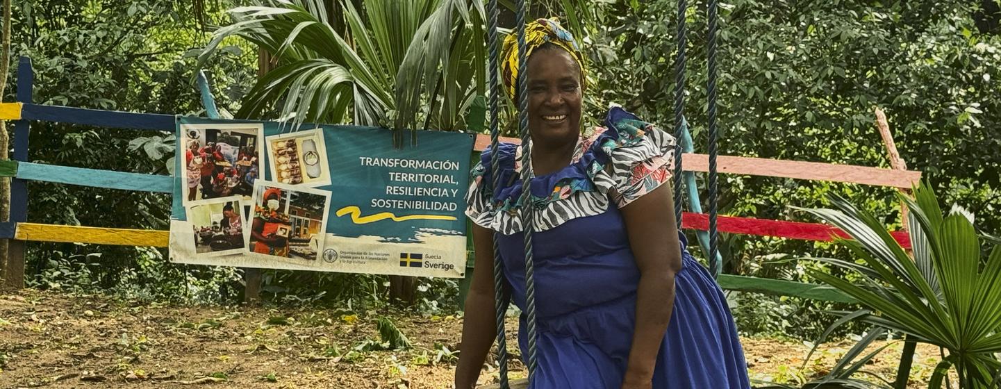 Saray Zuñiga sits on a swing at the eco-park built thanks the FAO-Sweden project. 