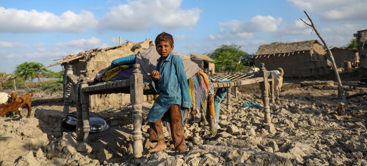 On 3 September 2022, four-year-old Rahim stands on the rubble of his house, destroyed by the floods in Pakistan.