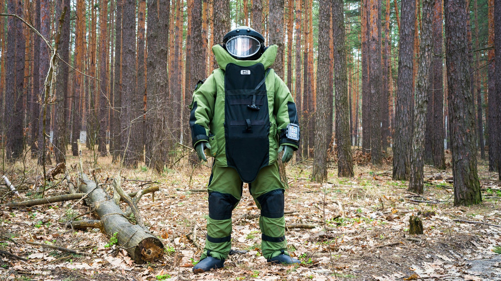 An Explosive Ordnance Disposal Specialist works in Ukraine to clear land of contamination from the war.