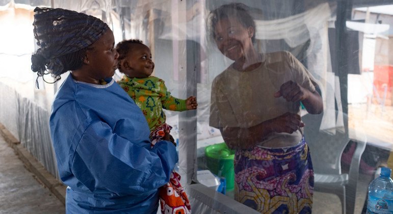 A plastic sheet separates a mother from her son at the Ebola treatment center in Beni, North Kivu province, Democratic Republic of the Congo.