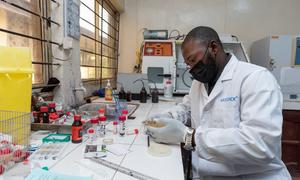 A doctor reviews a sample at a microbiology laboratory in a teaching hospital in Nigeria.