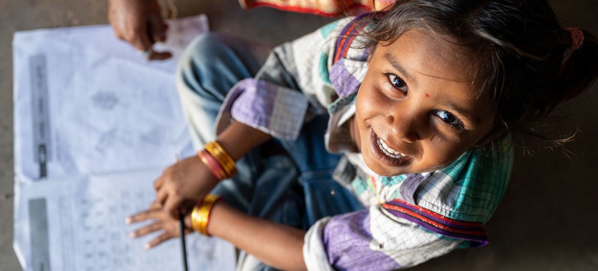 A young girl studies at home in Gujarat, India.