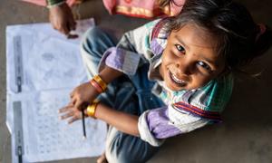 A young girl studies at home in Gujarat, India.