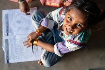 A young girl studies at home in Gujarat, India.