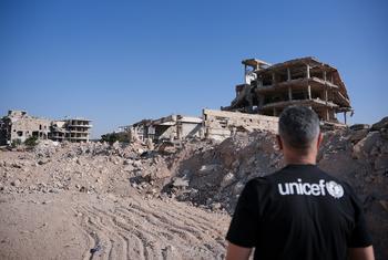Qays Sheikh Najib, UNICEF Syria Ambassador, stands with his back to the camera observing the rubble of destroyed buildings in Jobar, Rural Damascus, Syria, on 18 November 2025.
