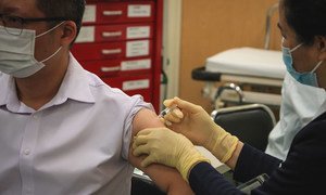 A man receives a COVID-19 vaccination in Macau, China.