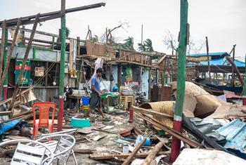 A local resident cleans up the extensive damage to his shop caused by Cyclone Mocha in Sittwe, Rakhine state, Myanmar.