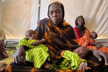 A Sudanese refugee sits with her three-month-old twins at a UNICEF-supported breastfeeding and nutrition awareness centre in Eastern Chad.