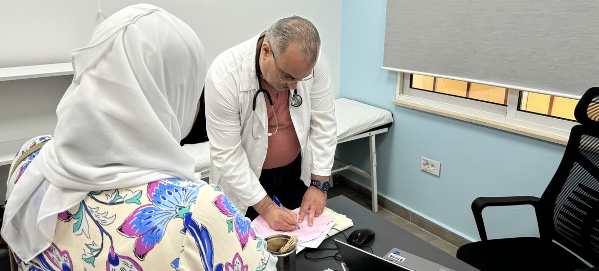 Dr. Mohamed Badran, the head of the UNRWA health centre in the Al Biddawi camp, seeing a patient.