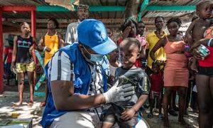 Local displaced and homeless Haitians gather for free medical treatment at an IOM mobile clinic in Place Clercine in Tabarre, Port-au-Prince.