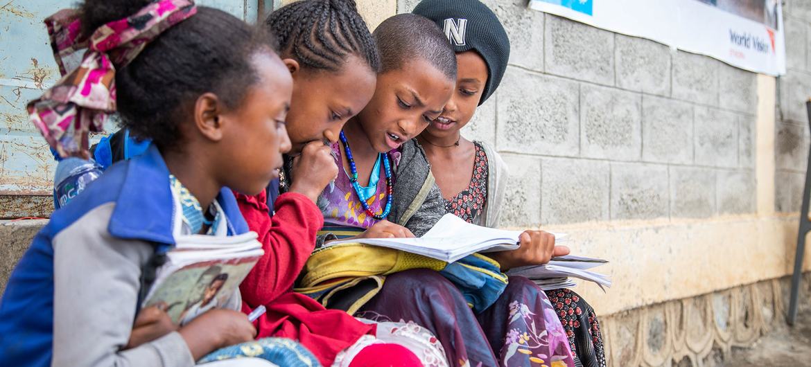 Young girls sit together and study outside a UNICEF-supported school in central Tigray, Ethiopia.