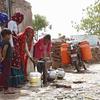 A group of women fill water pots and containers in Barki village, located in the Karauli district of Rajasthan, India. 