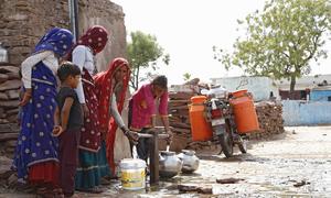 A group of women fill water pots and containers in Barki village, located in the Karauli district of Rajasthan, India. 