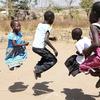Niños refugiados saltan la cuerda en el asentamiento de Palabek Ogili, en Sudán del Sur.