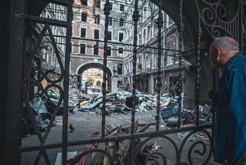 Un hombre observa un negocio dañado en Kharkiv, Ucrania.