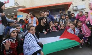 Children in Gaza display the Palestinian flag following the ceasefire.