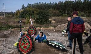 A mother in Bucha, Ukraine, buries her son whose body was found along with 450 others after soldiers retreated from the town. 