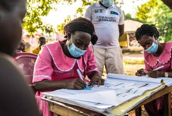 Nurses work at a mobile COVID-19 vaccination clinic in Rofunta, Sierra Leone, in December 2022.
