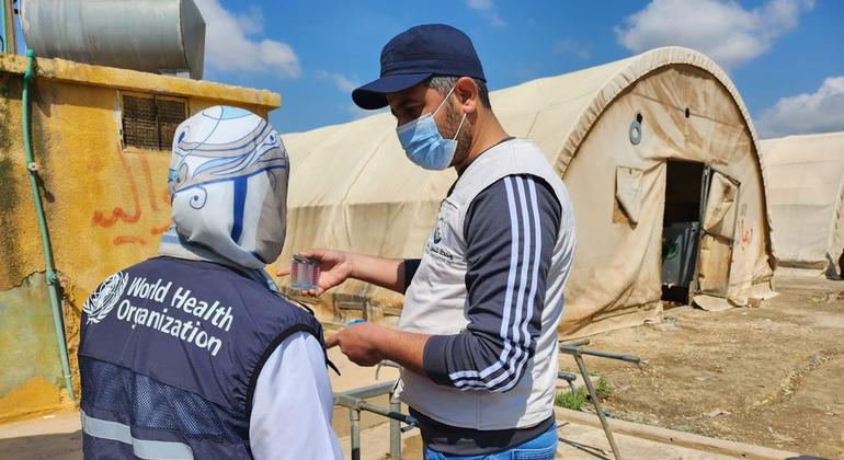کارکنان سازمان جهانی بهداشت آب آشامیدنی را در یک مرکز پذیرش در شمال غرب سوریه آزمایش می کنند.
