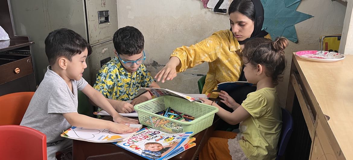 Farishta Haidari with refugee kids. Farishta Haidari with refugee kids.