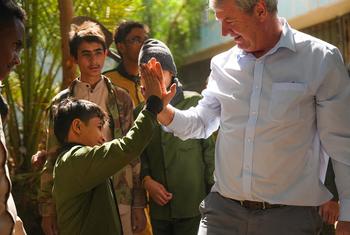 بيتر هوكينز، ممثل UNICEF في اليمن، يصافح طالباً في مدرسة الشعب بصنعاء خلال فعالية بمناسبة اليوم العالمي للطفل.