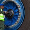 A worker repairs a wheel of a giant haul truck at a uranium mine in Namibia.