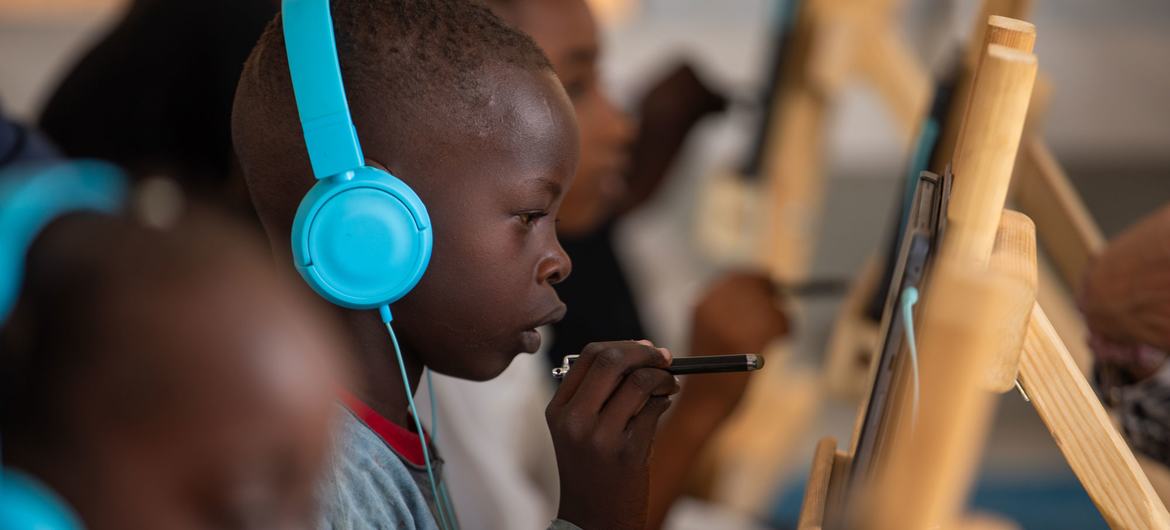 Children attend an e-learning session at Abdullah Naj internally displaced people's gathering point in Port Sudan.