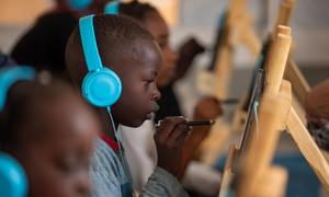 Children attend an e-learning session at Abdullah Naj internally displaced people's gathering point in Port Sudan.