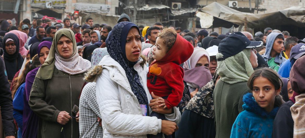 Women and children queue for bread at a bakery in Khan Younis.