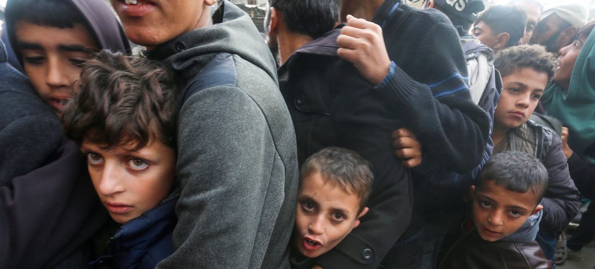 People queue for bread at a bakery in Khan Younis, Gaza.