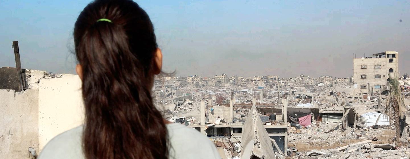 Selin Al-Dada, una niña de Gaza, se encuentra en el tejado de su casa destruida, contemplando la devastación que se extiende por toda la ciudad.