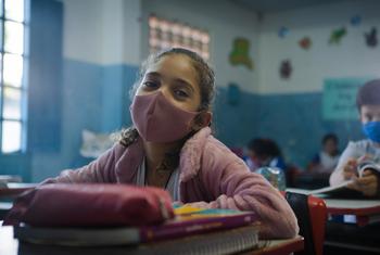 A child, wearing a mask, attends classes in rural Brazil. (2021 photo)