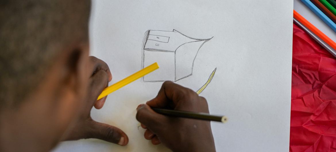 A child displaced by violence in city of Mirebalais, Haiti, draws a picture of their new home. A child displaced by violence in city of Mirebalais, Haiti, draws a picture of their new home.