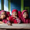 Girls await their turns to get immunized at Rusung Raya Elementary School, in Indonesia.