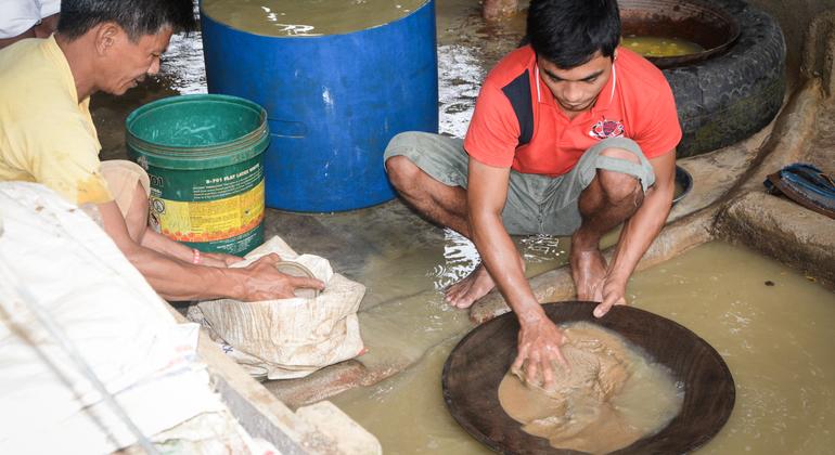 عمال يستخدمون أيديهم العارية للبحث عن الذهب باستخدام الزئبق السام في كامارينس نورتي بالفلبين.