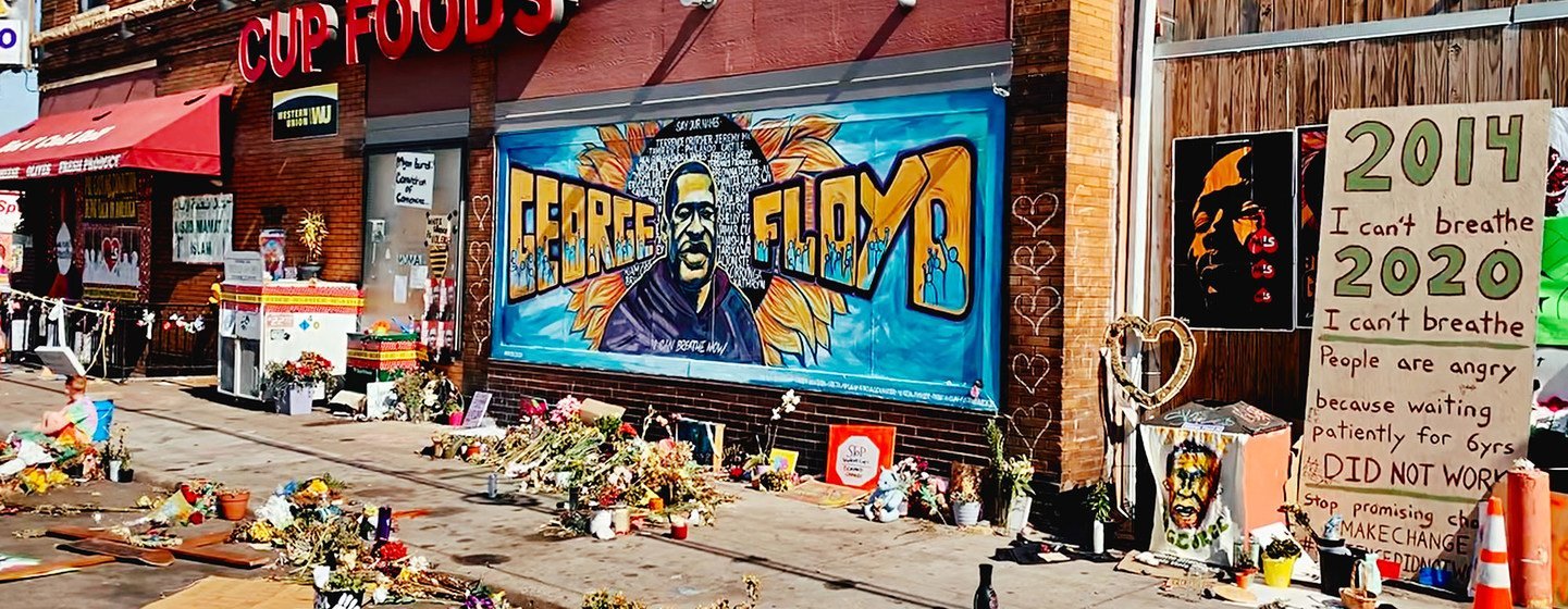 Tributes are left for George Floyd outside the grocery store in the US state of Minnesota where he was murdered by a police officer.