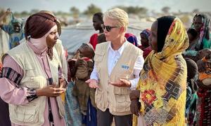 WFP Executive Director Cindy McCain (centre),  talks to staff at refugee camp in Chad.